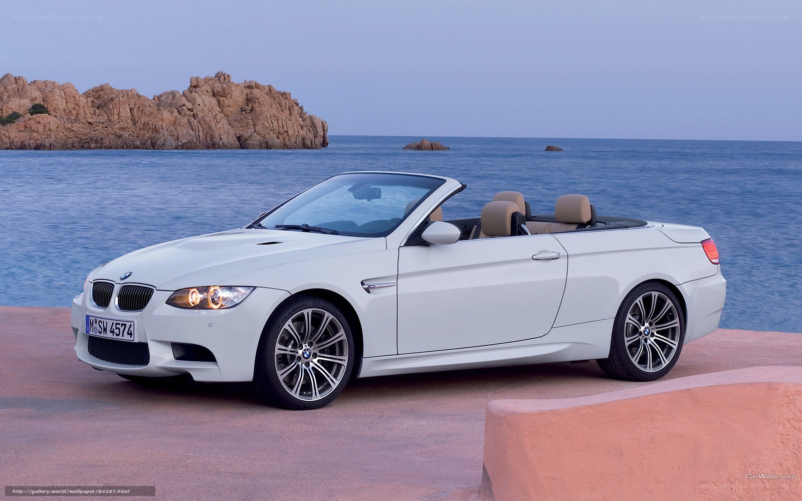 White BMW M3 convertible by the sea