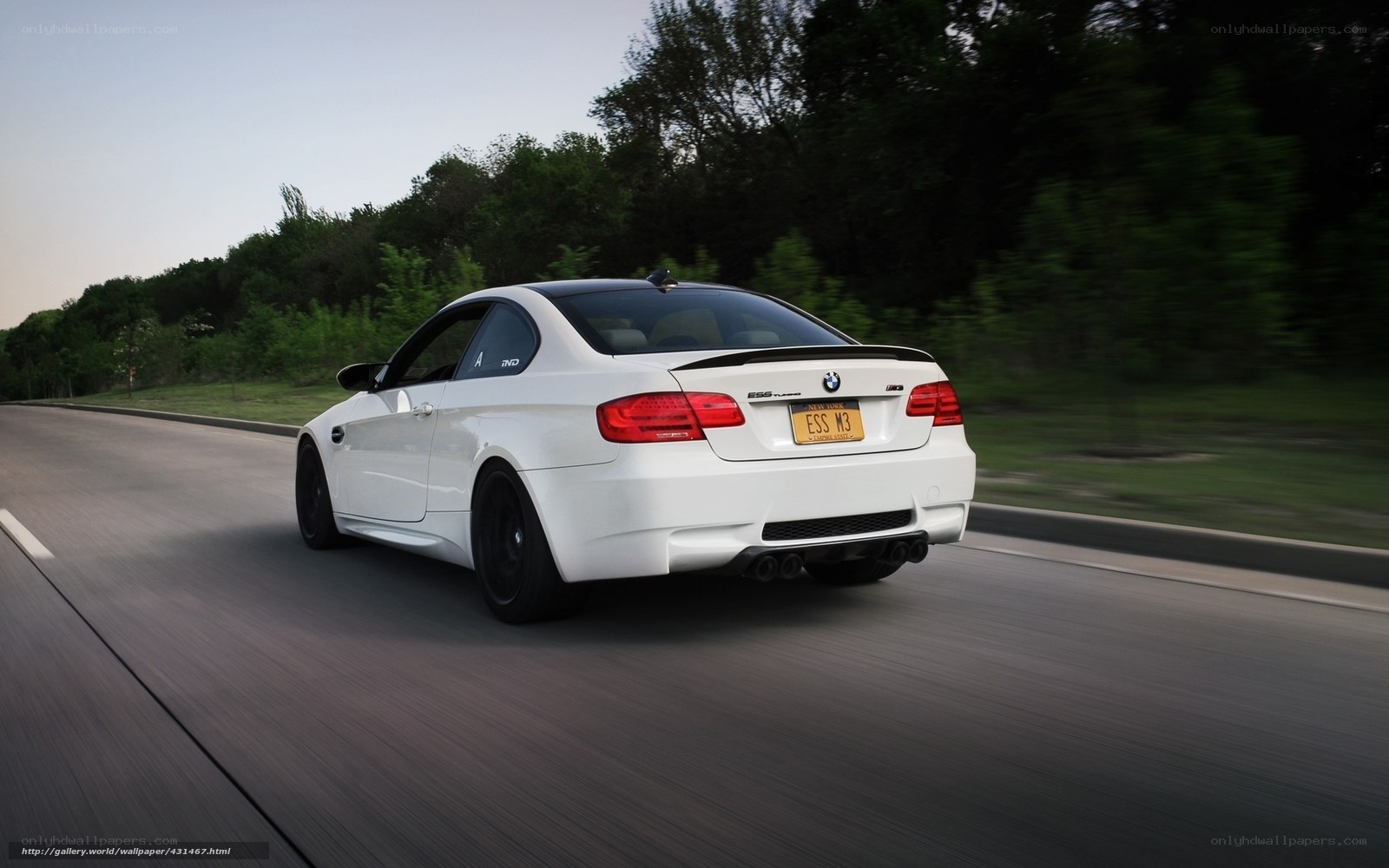 white bmw m3 driving on road