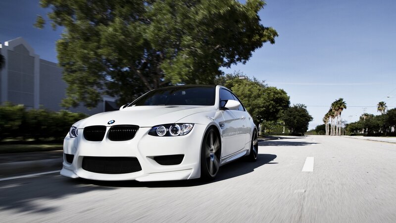 white bmw m3 driving on road