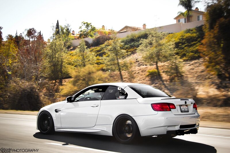 white bmw m3 driving on road