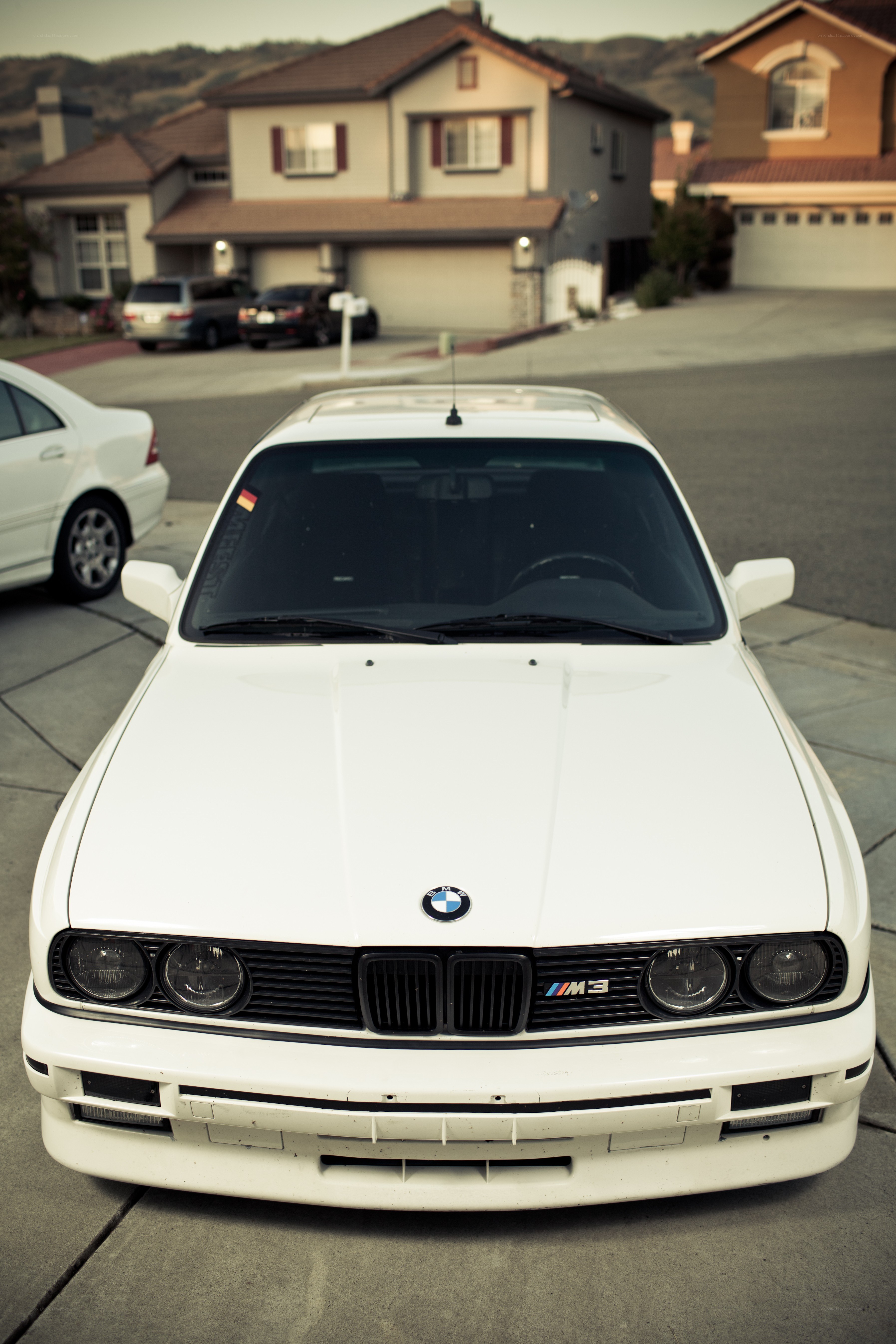 white bmw m3 in driveway