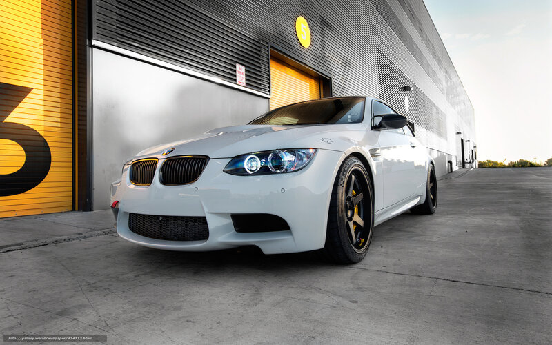 White BMW M3 in front of garage
