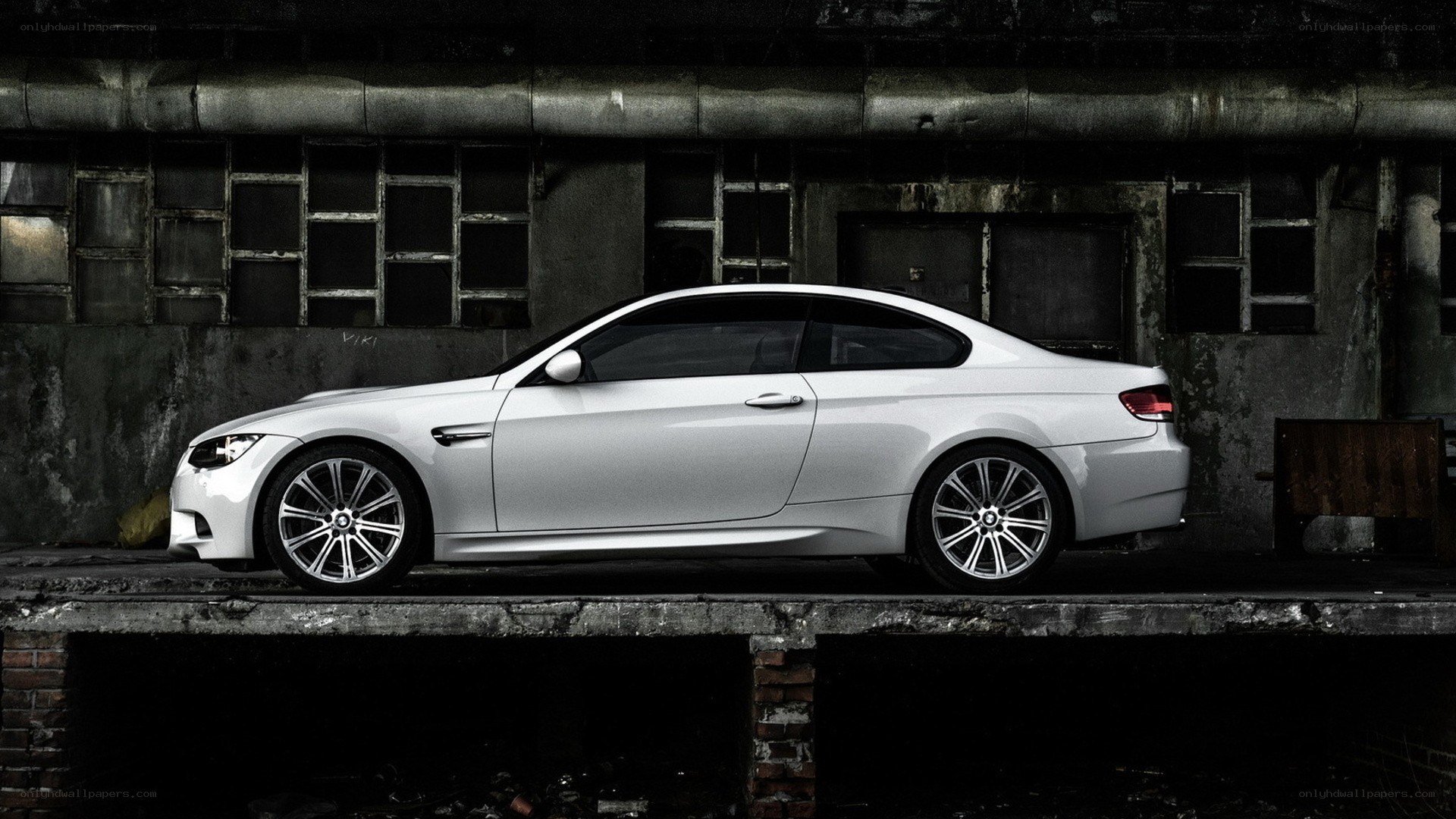 white bmw m3 in industrial setting