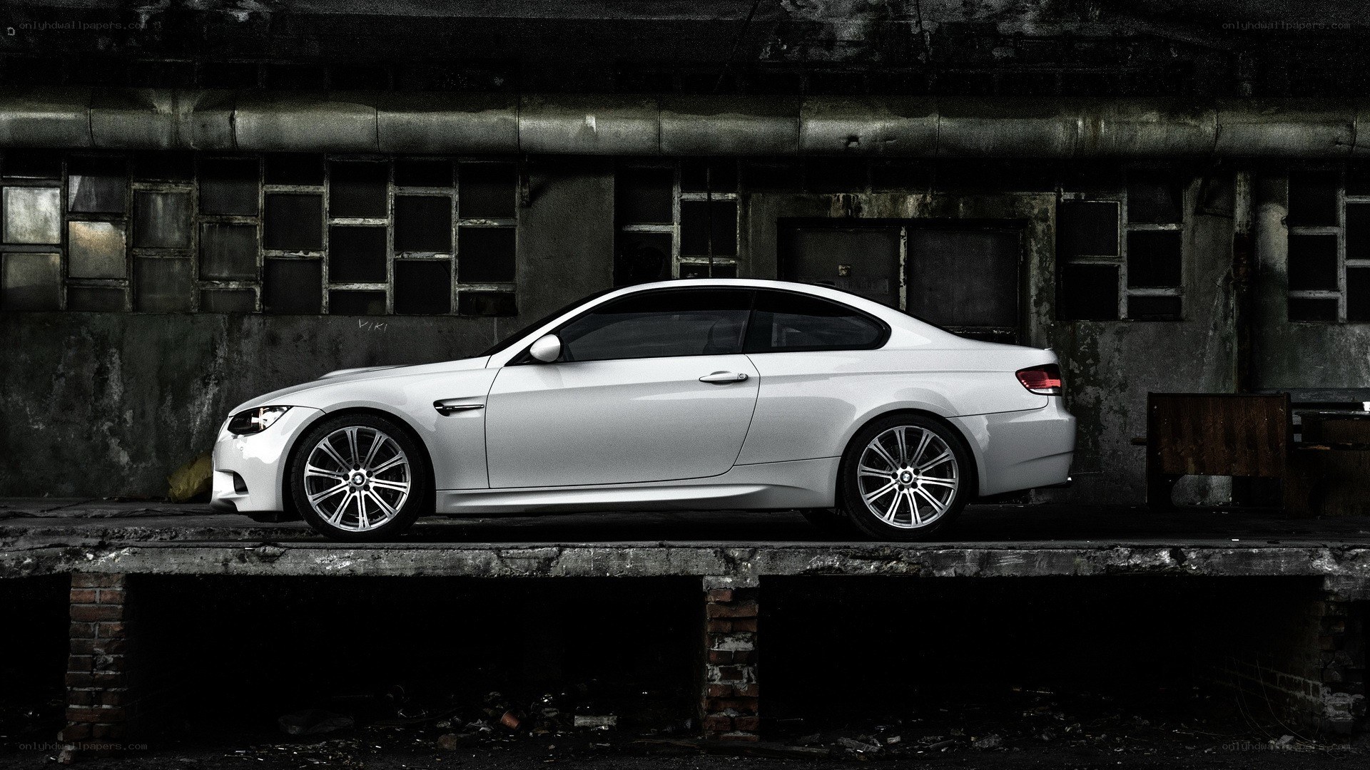 White BMW M3 in industrial setting