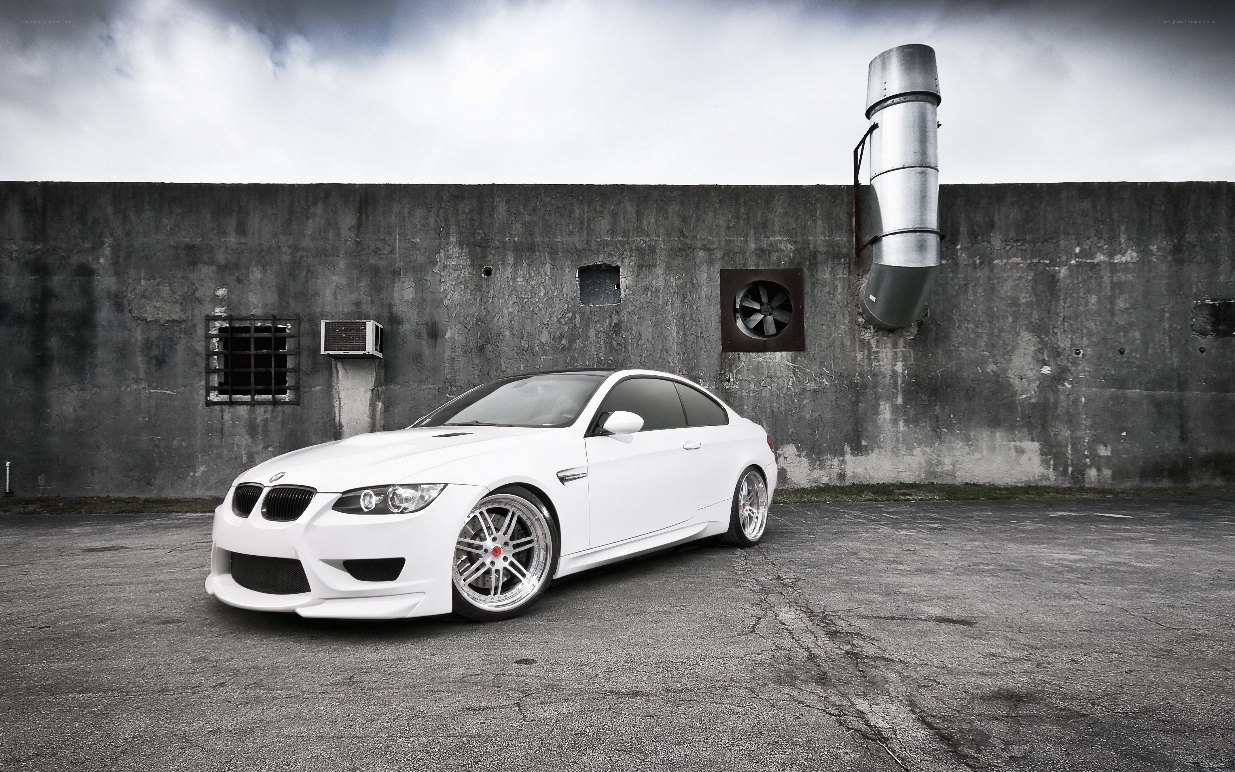 white bmw m3 in industrial setting