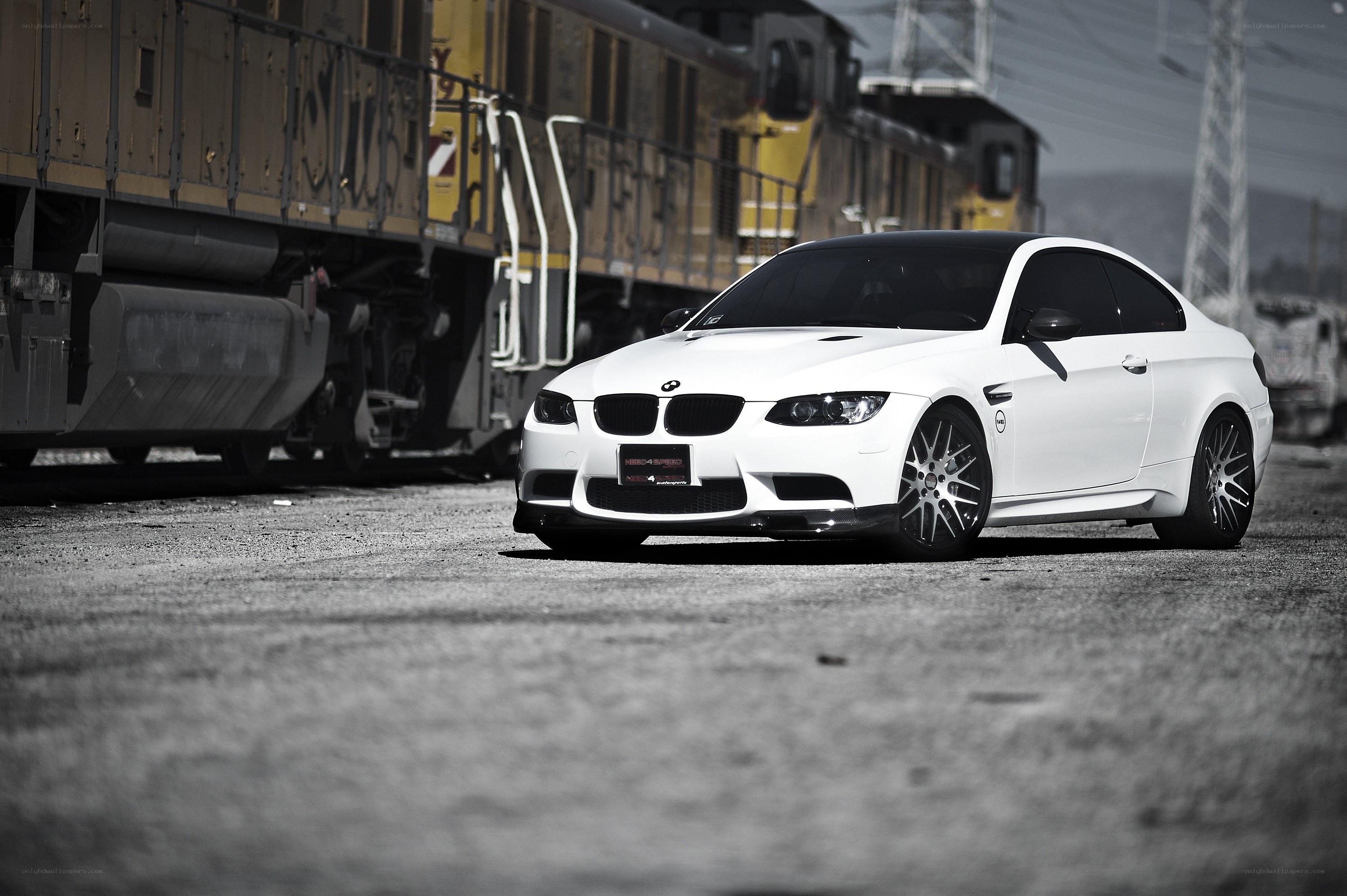 White BMW M3 near train