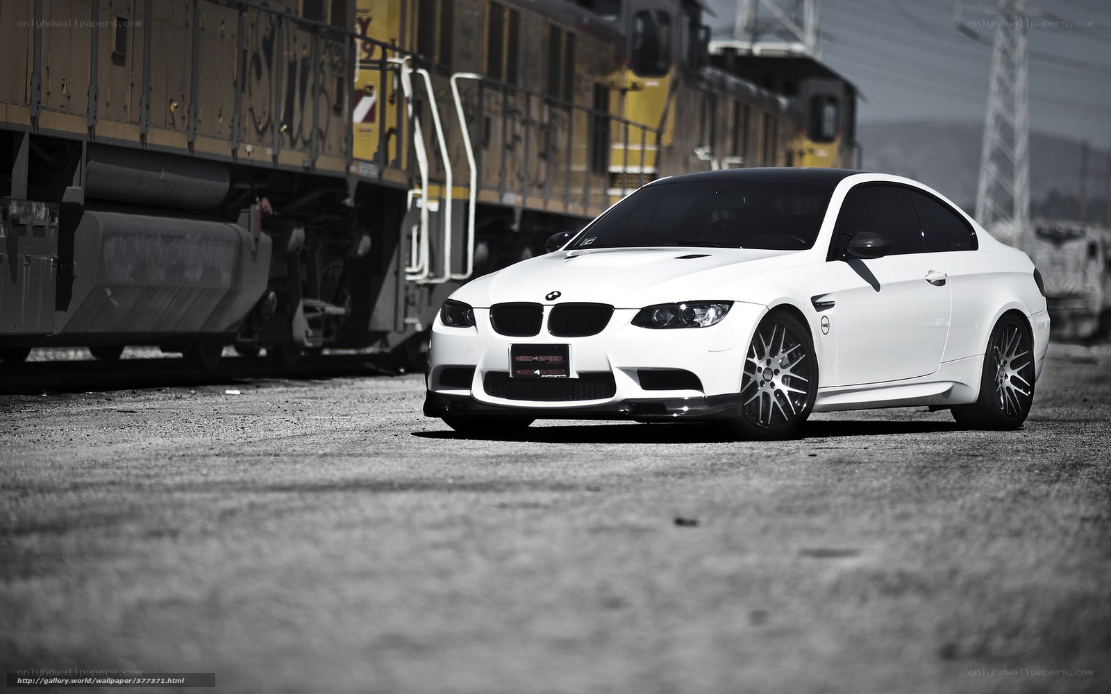 White BMW M3 near train