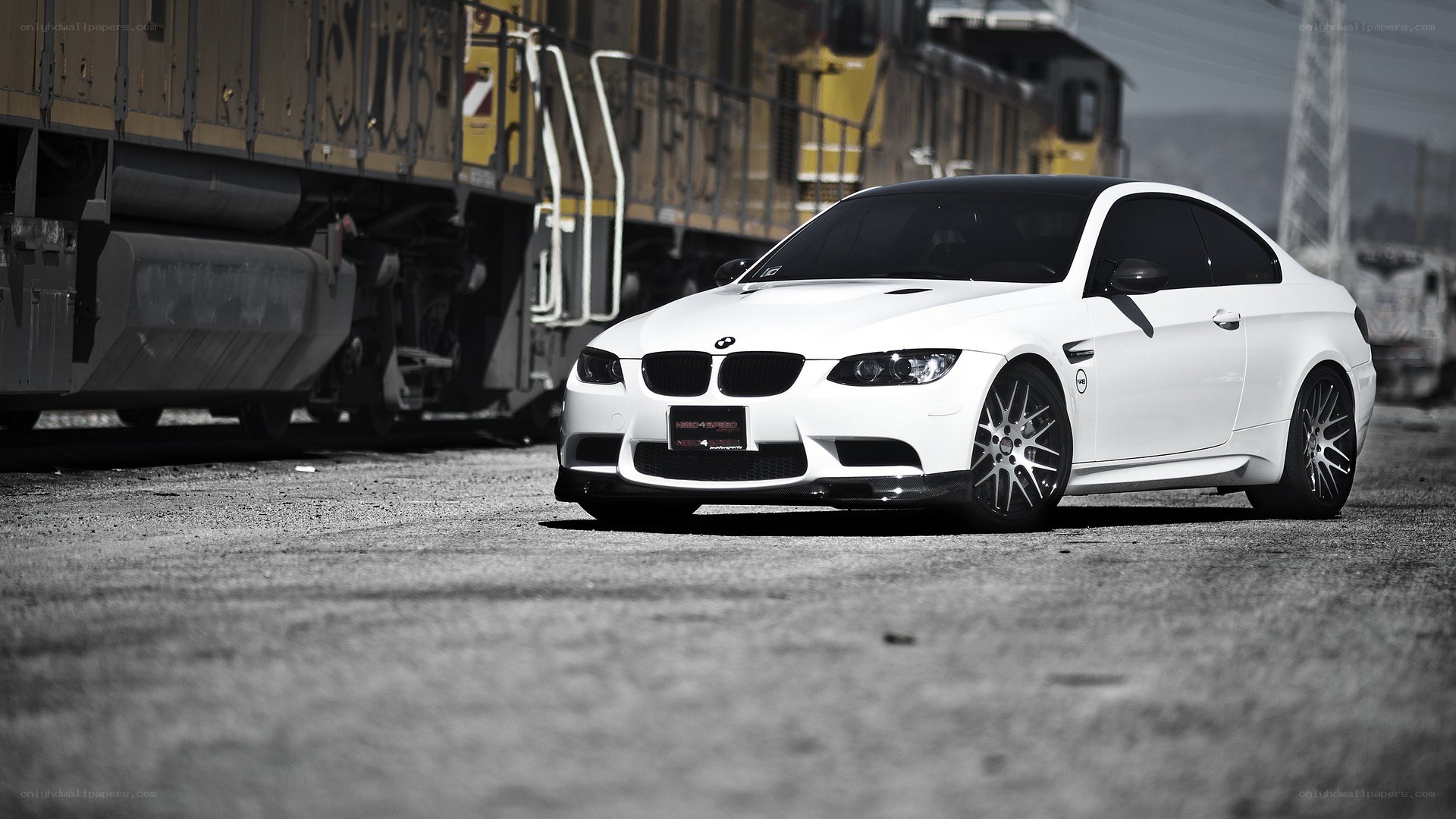 White BMW M3 next to train