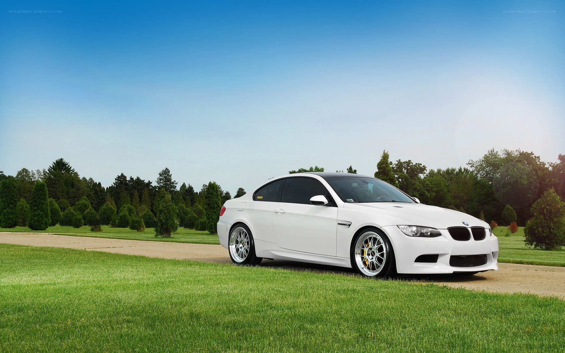 White BMW M3 on a grassy path