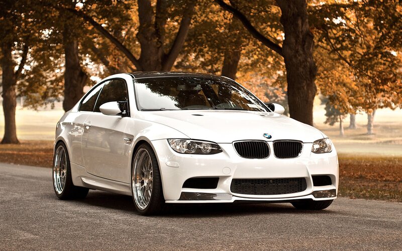 White BMW M3 on a tree-lined road
