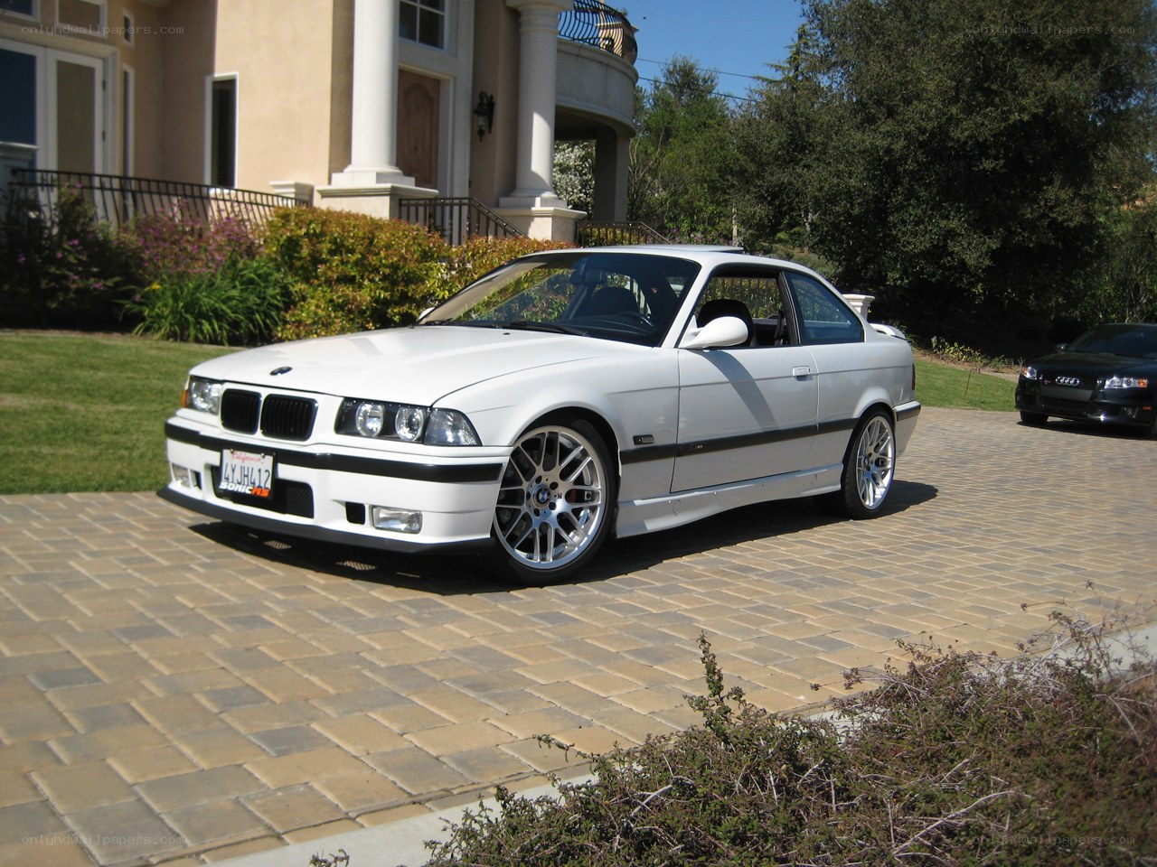 White BMW M3 on driveway
