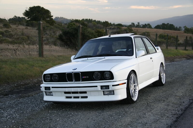 white bmw m3 on gravel road