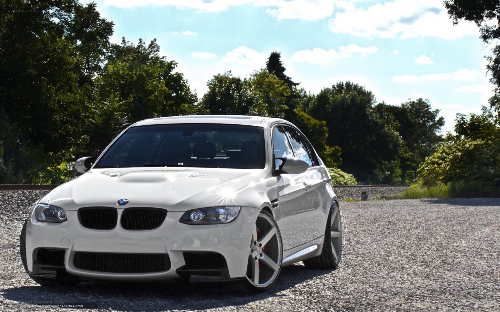 white bmw m3 on gravel