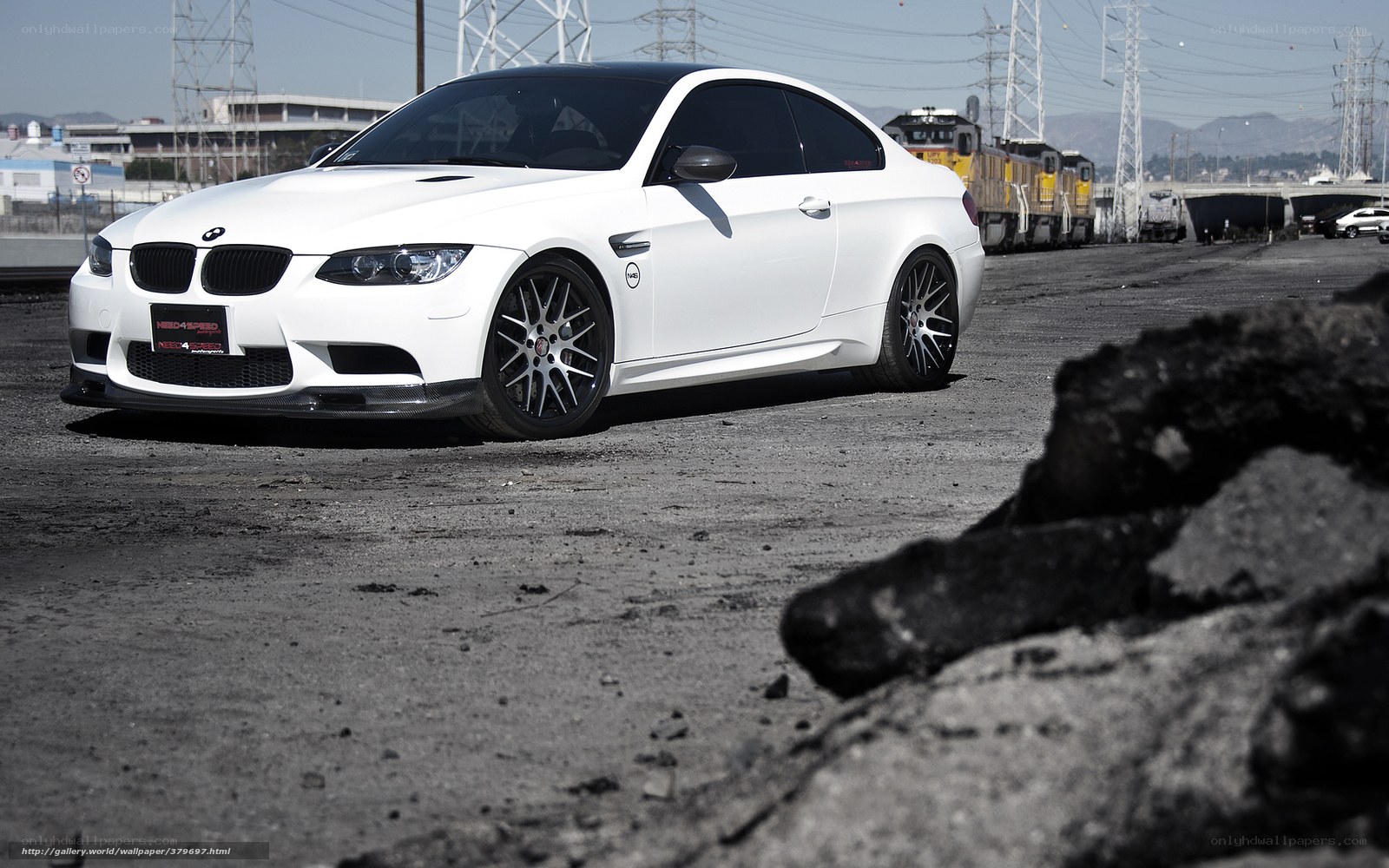 white bmw m3 on industrial lot