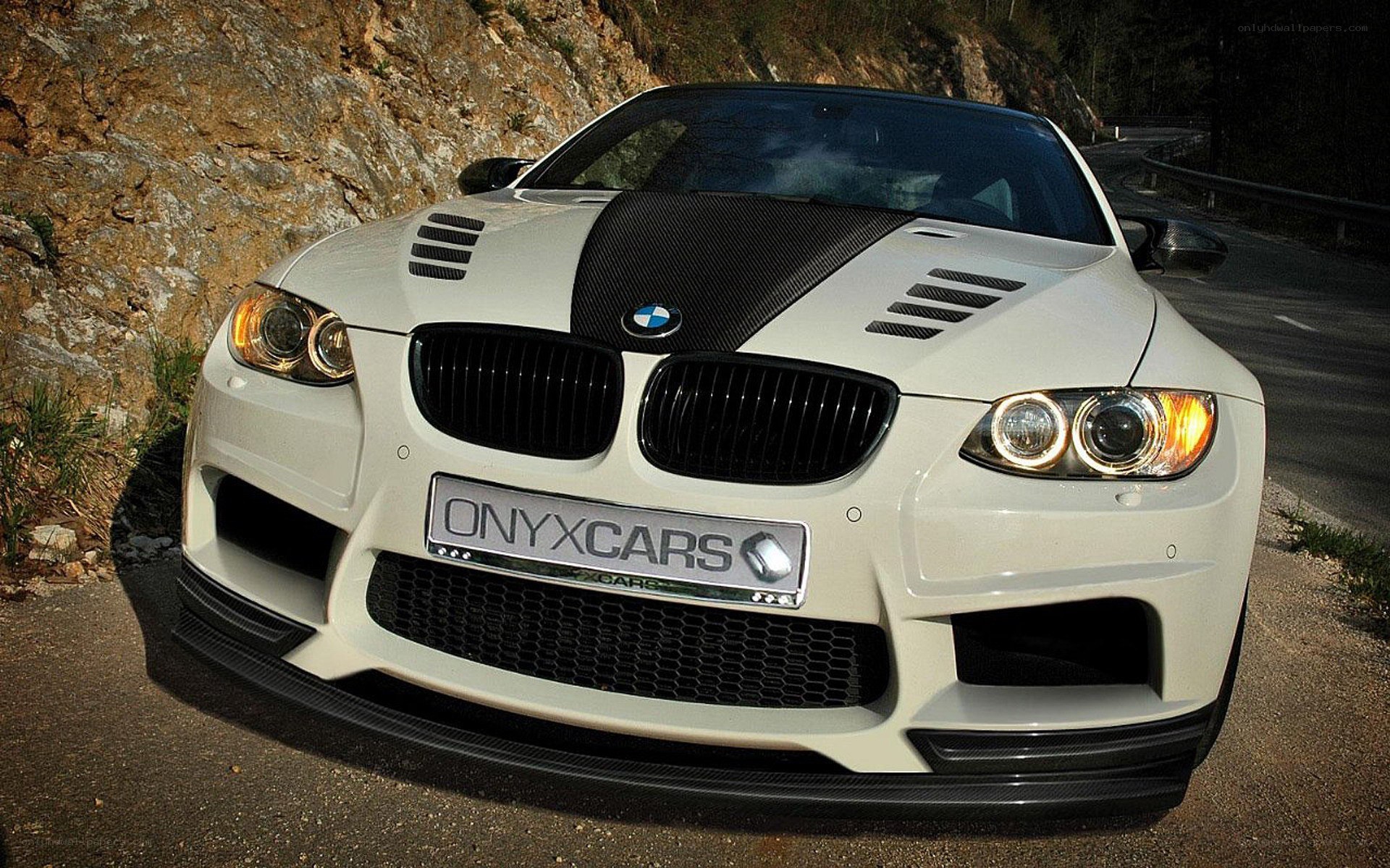 white bmw m3 on mountain road
