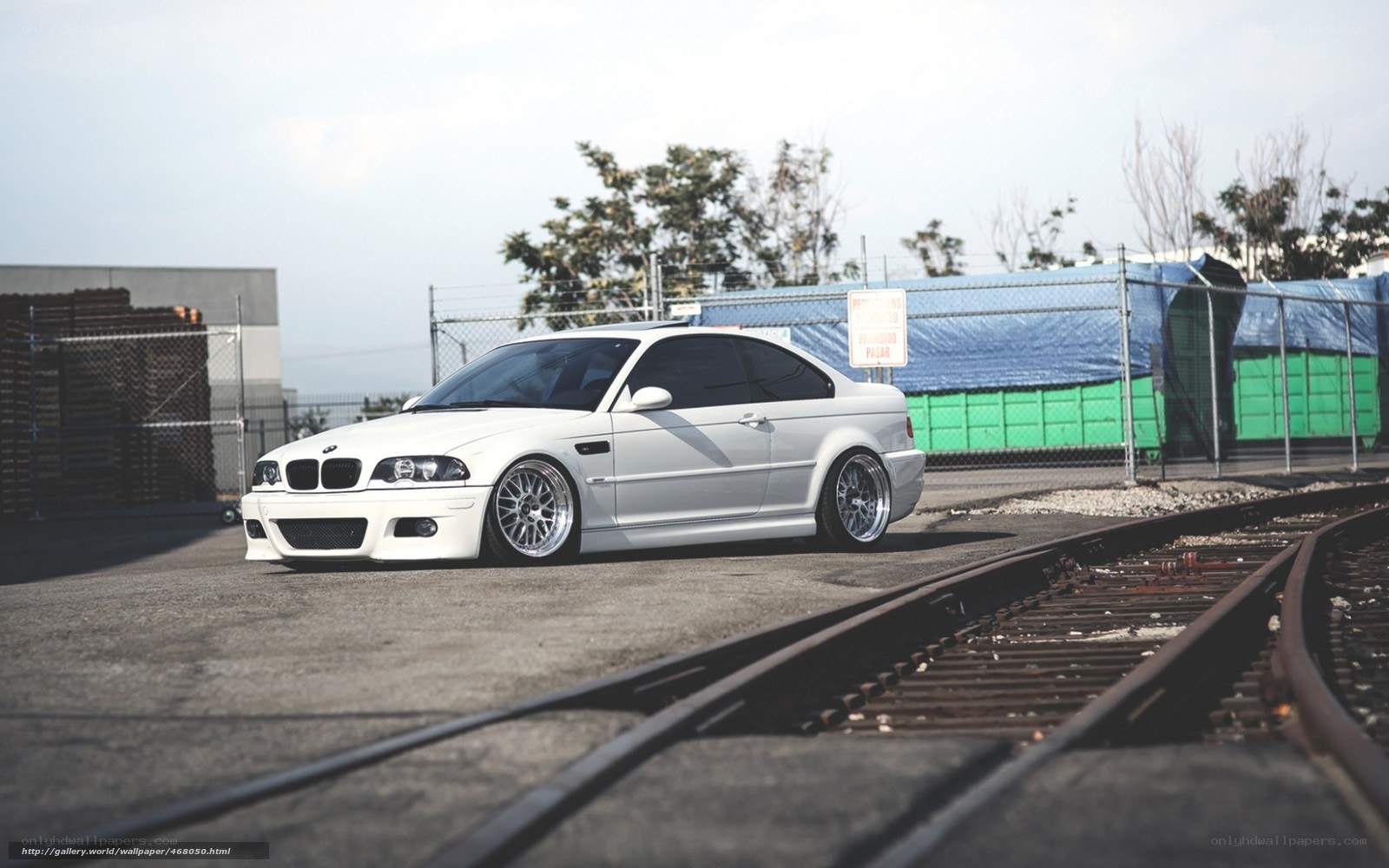 white bmw m3 on train tracks