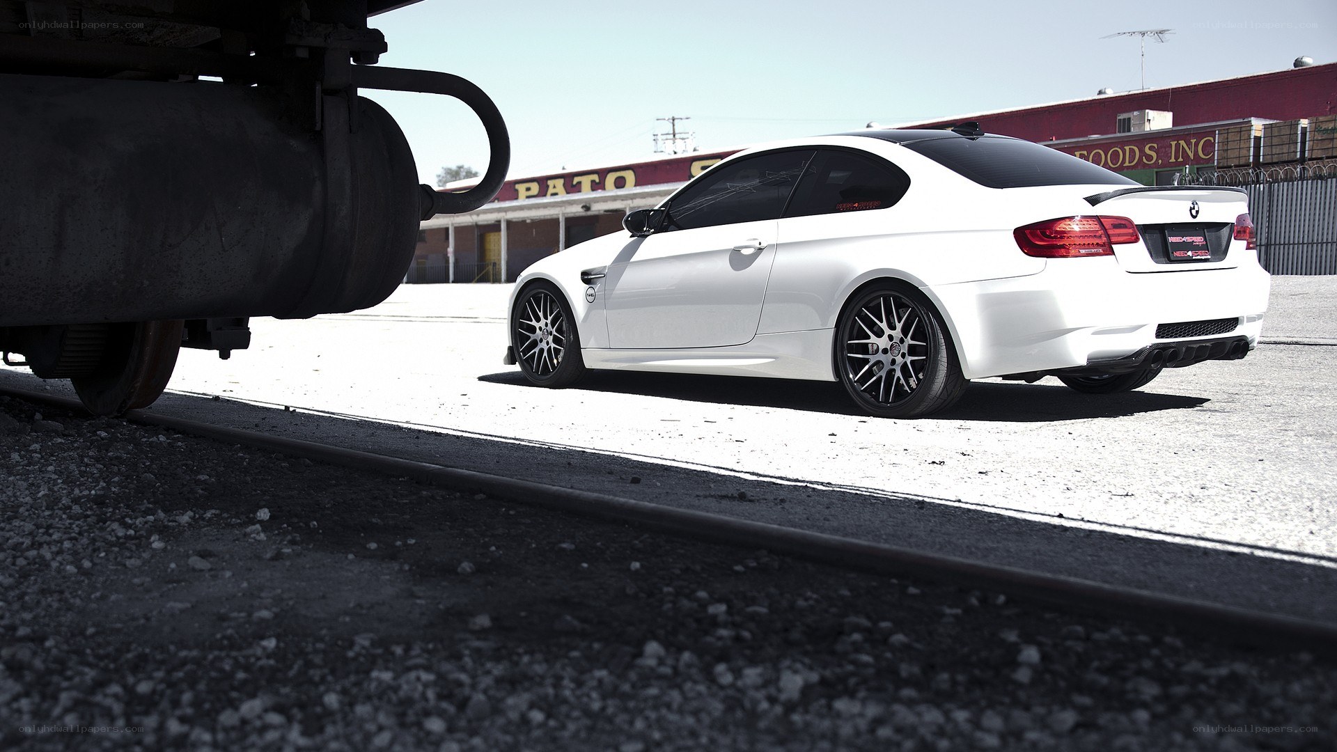 white bmw m3 on train tracks