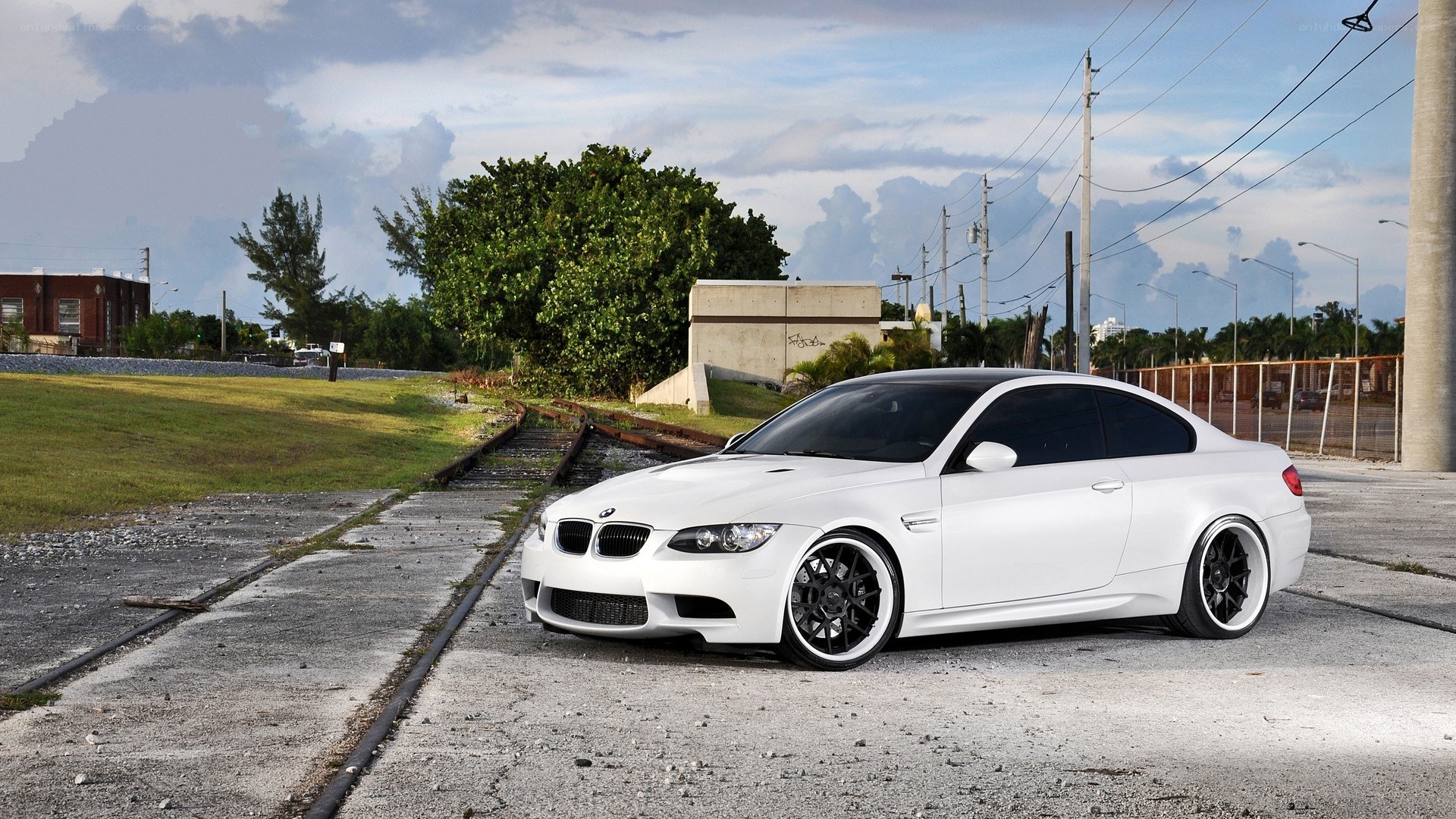 white bmw m3 on train tracks