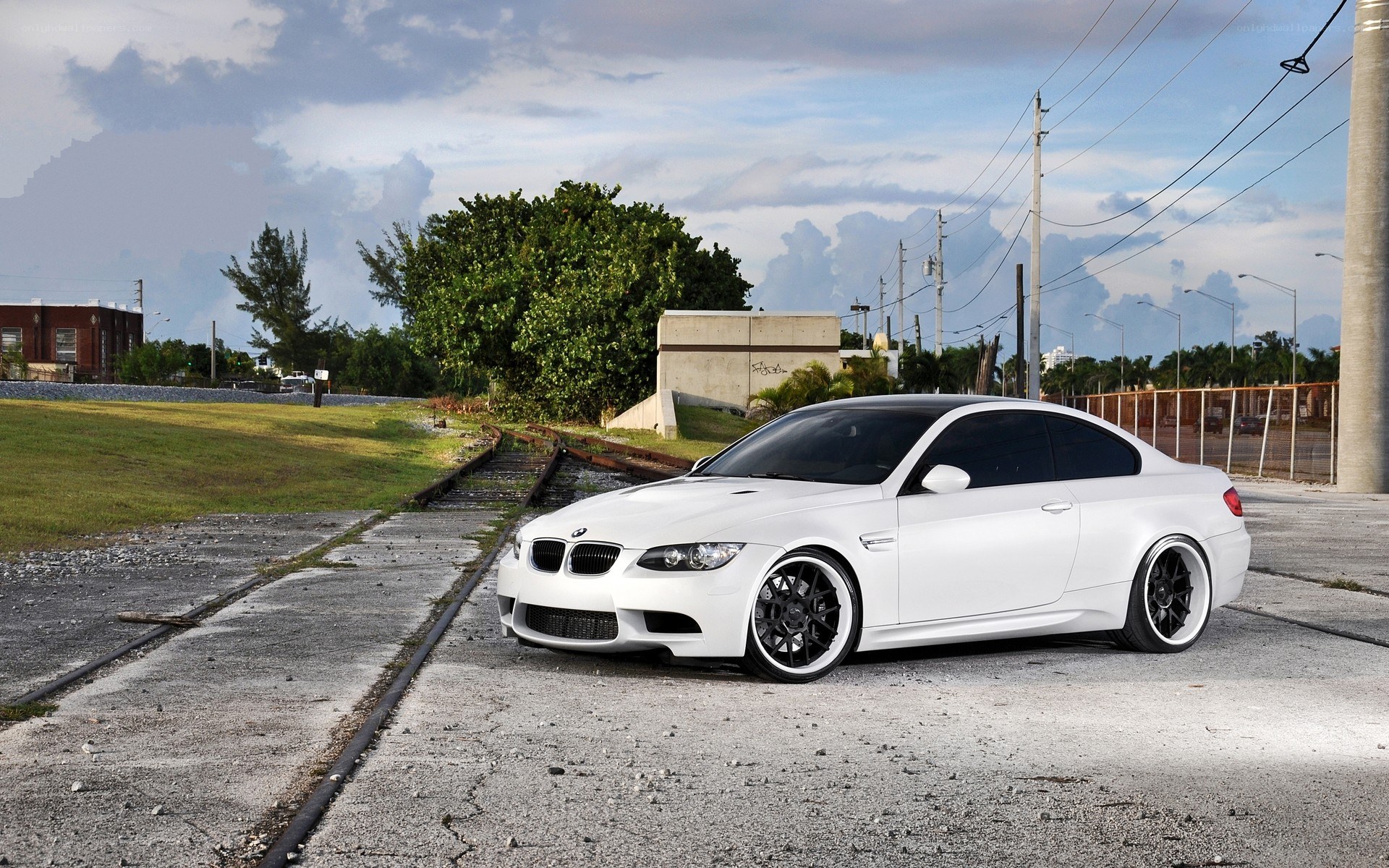 white bmw m3 on train tracks