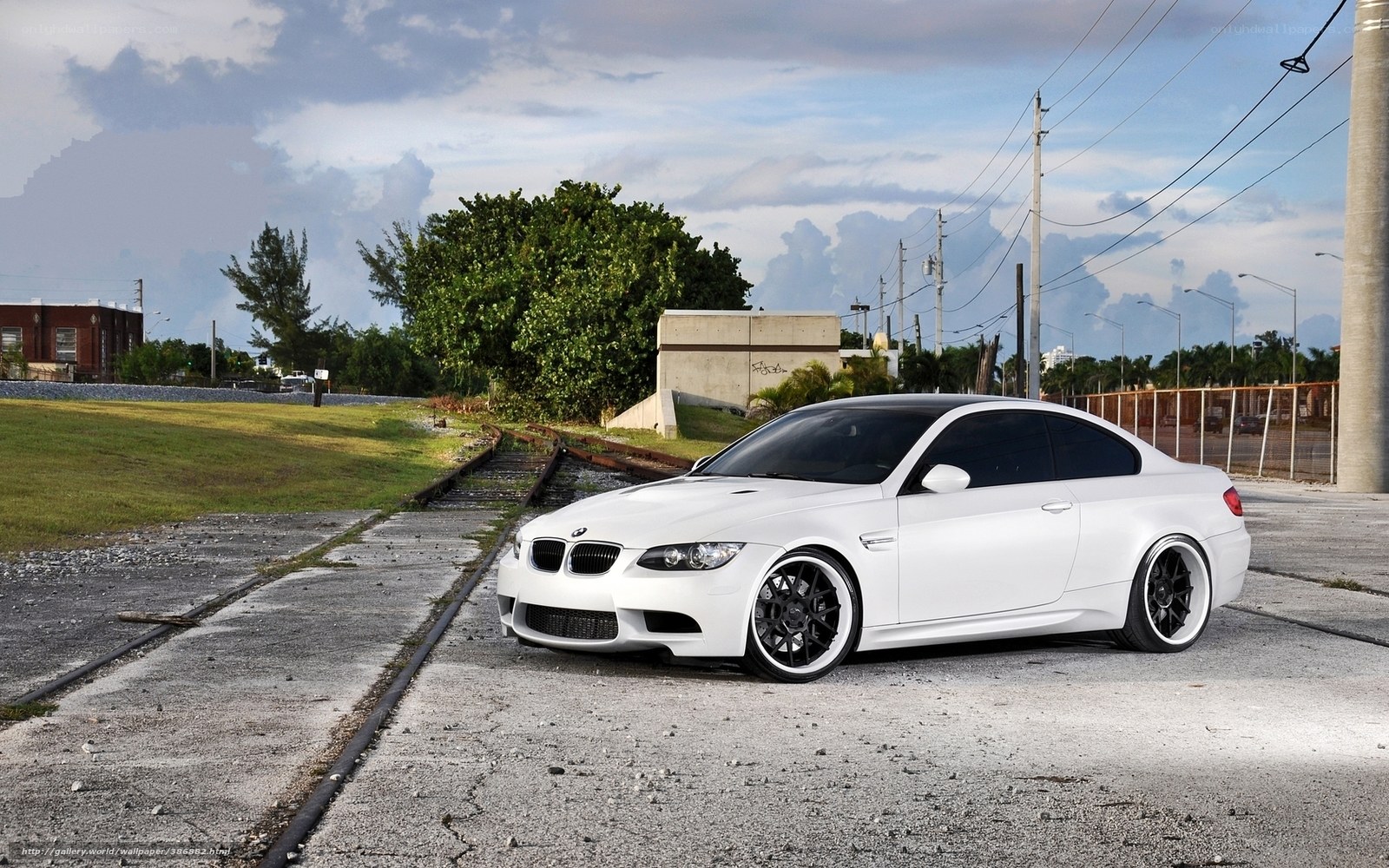 white bmw m3 on train tracks