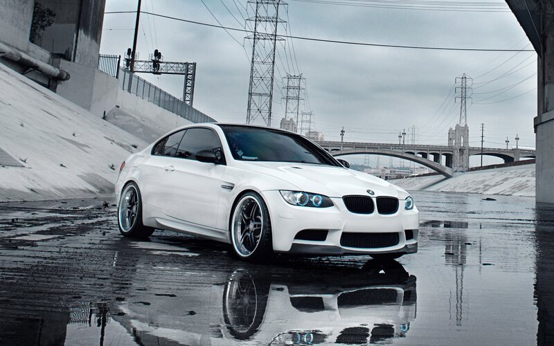 White BMW M3 on wet pavement