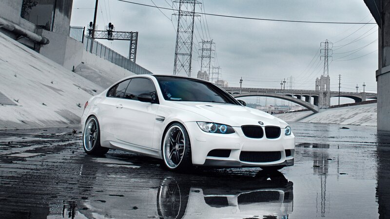 White BMW M3 on wet pavement