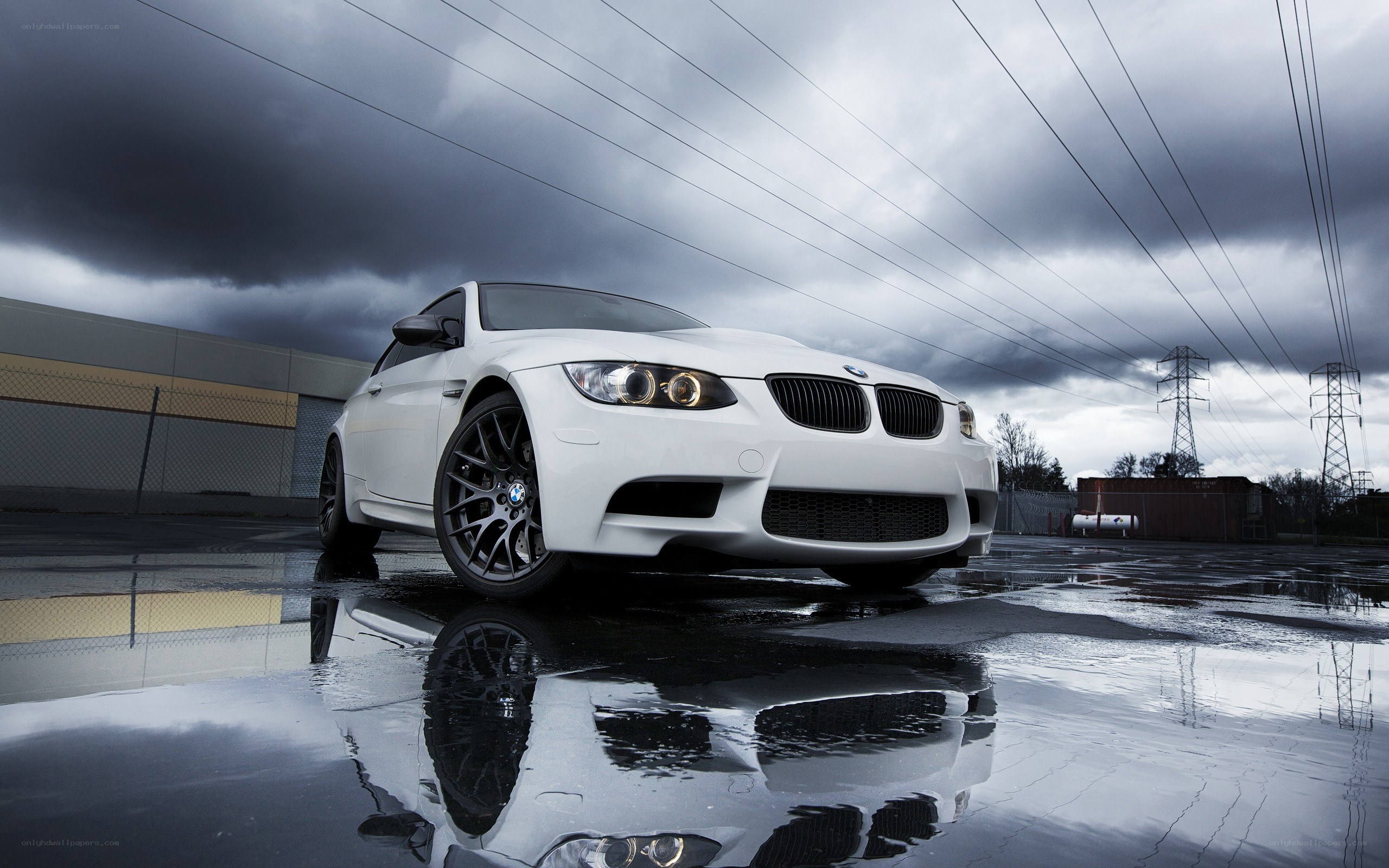 White BMW M3 on wet pavement