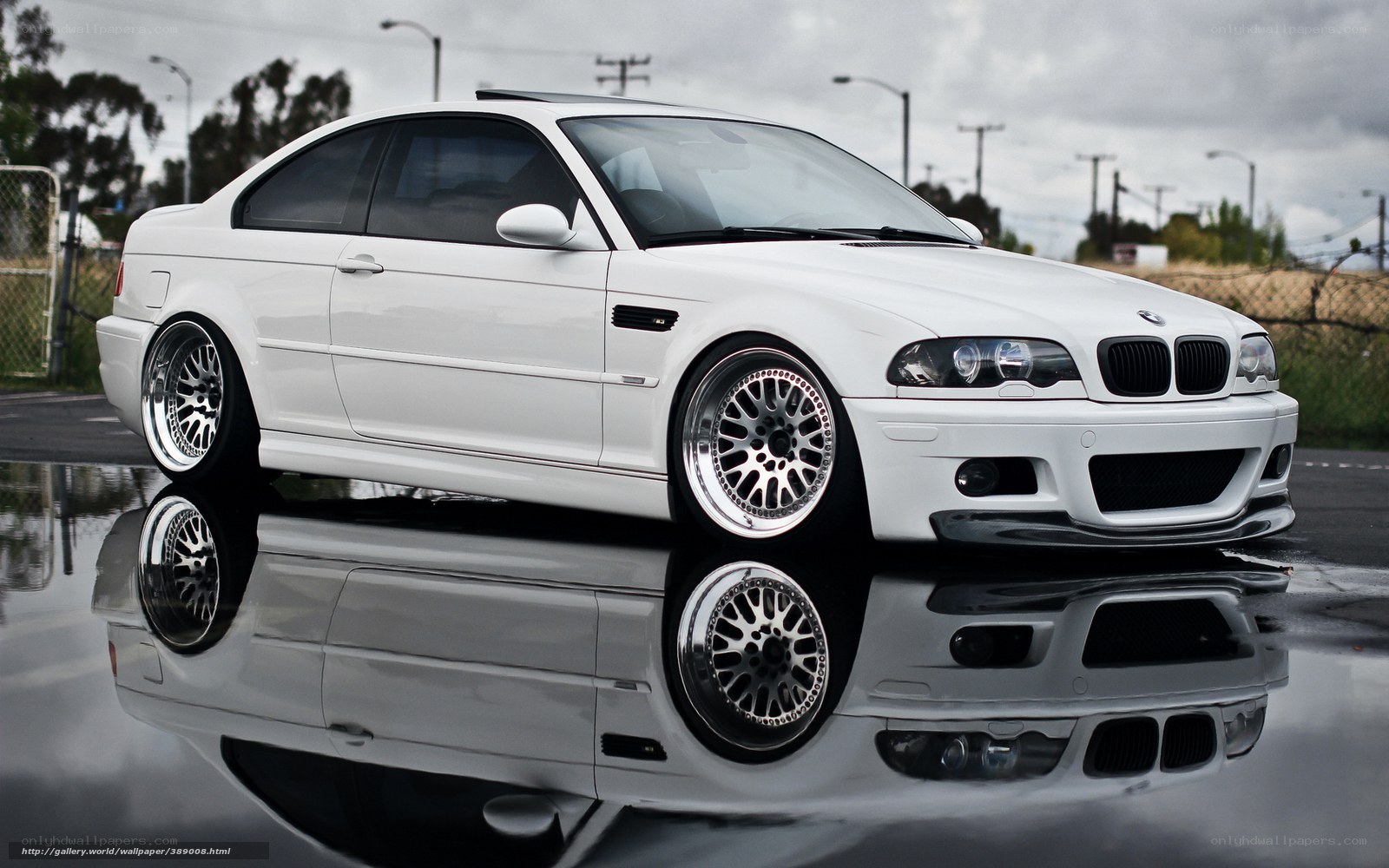 white bmw m3 on wet pavement
