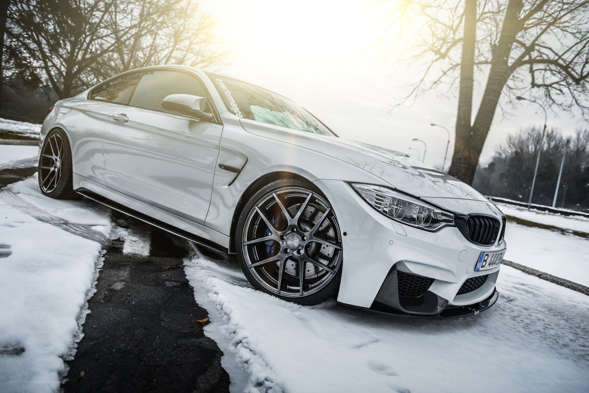 White BMW M4 in snowy setting
