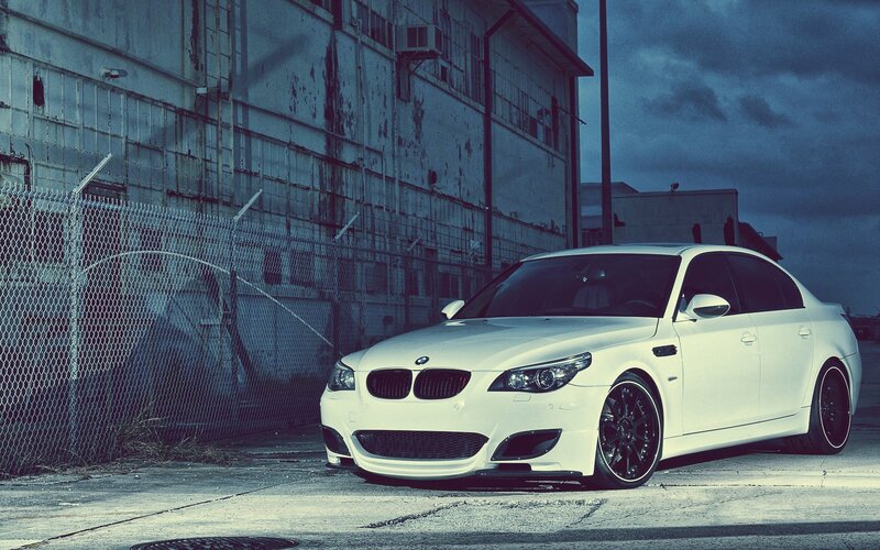 white bmw m5 in industrial area