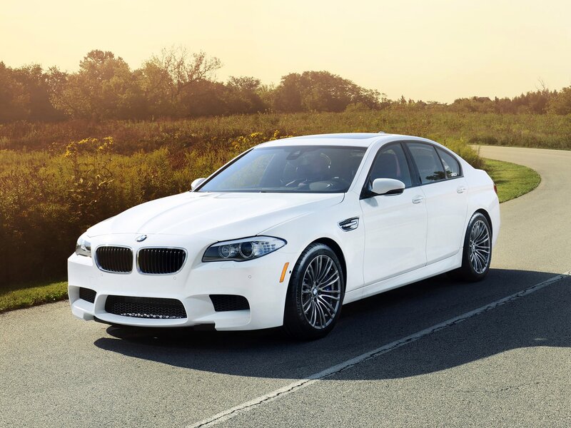 White BMW M5 on a country road