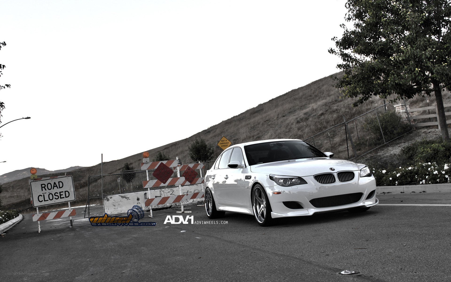 White BMW M5 on closed road