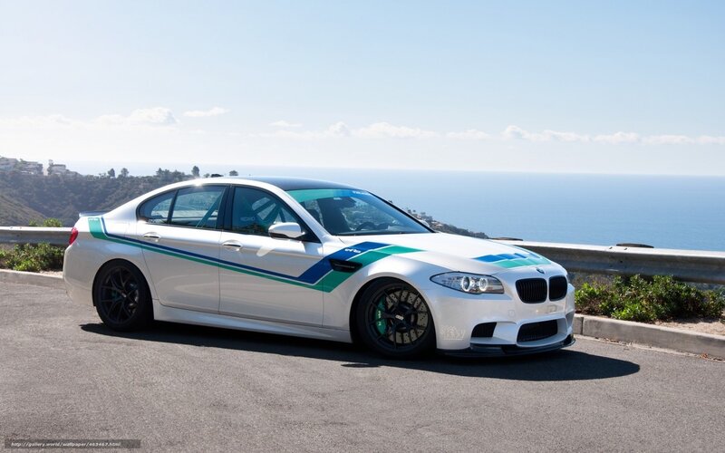 white bmw m5 on coastal road