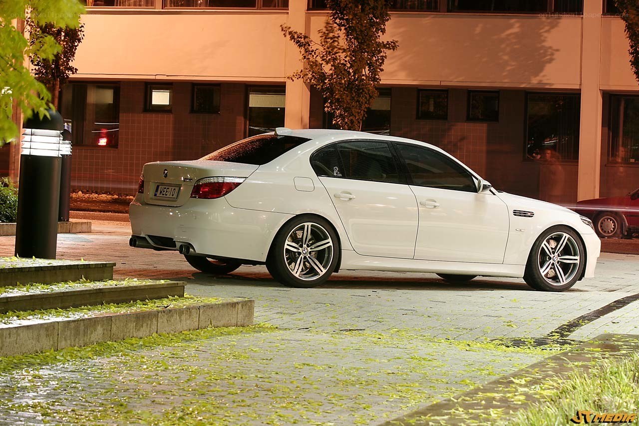 white bmw m5 parked at night