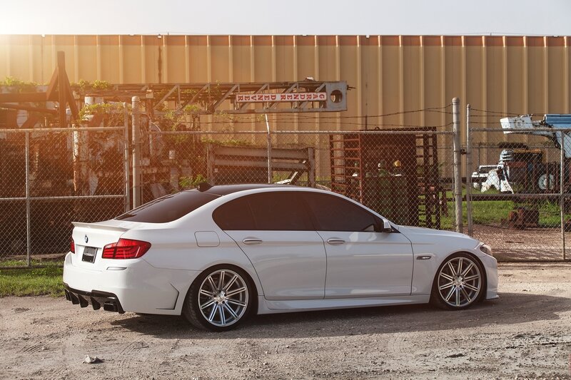 white bmw m5 parked outside