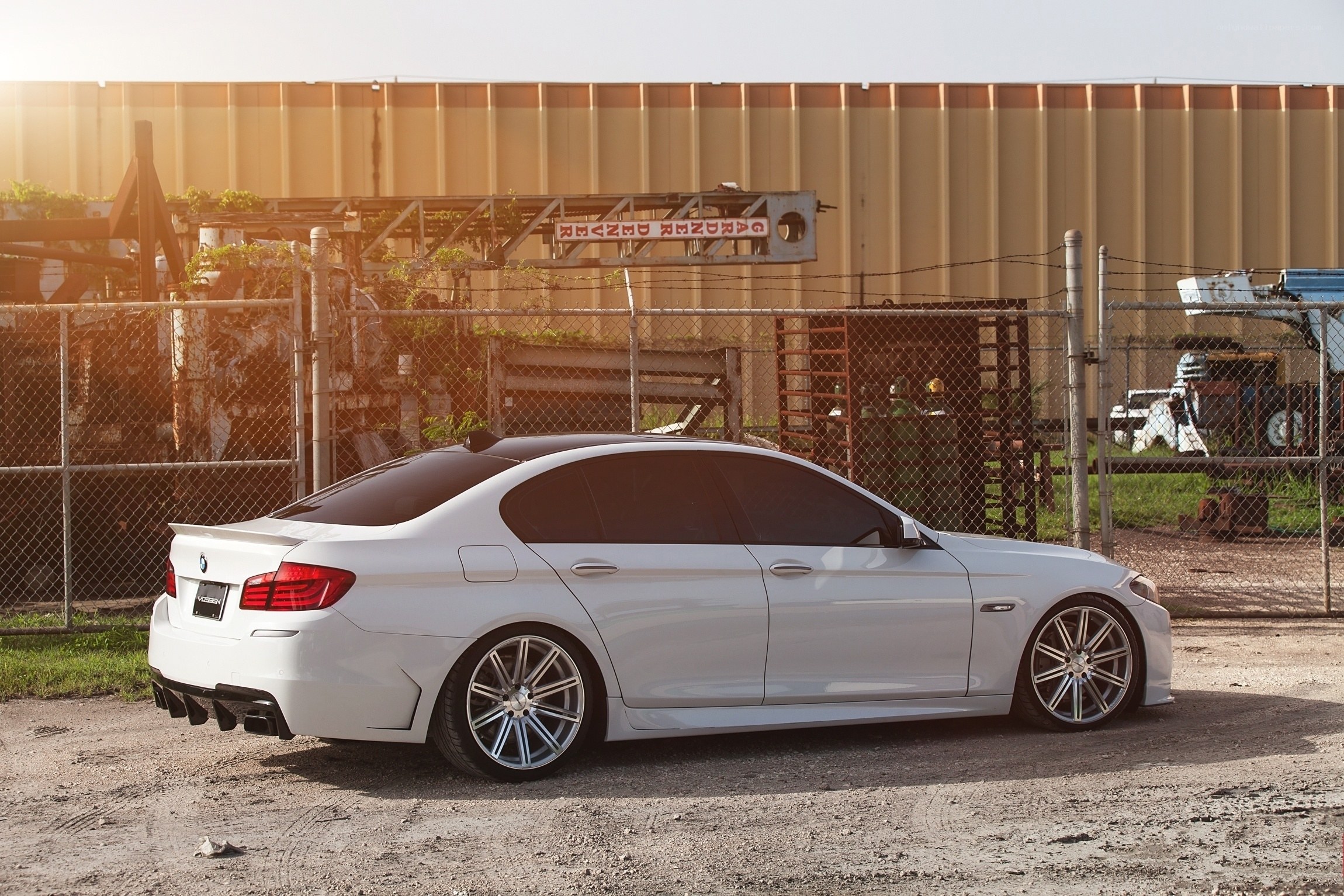 white bmw m5 parked outside