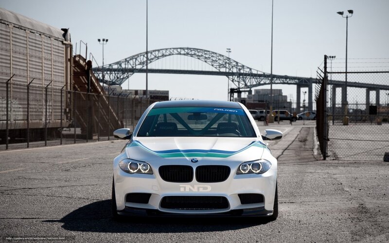 white bmw m5 with racing stripes