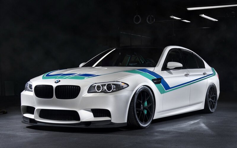 white bmw m5 with racing stripes
