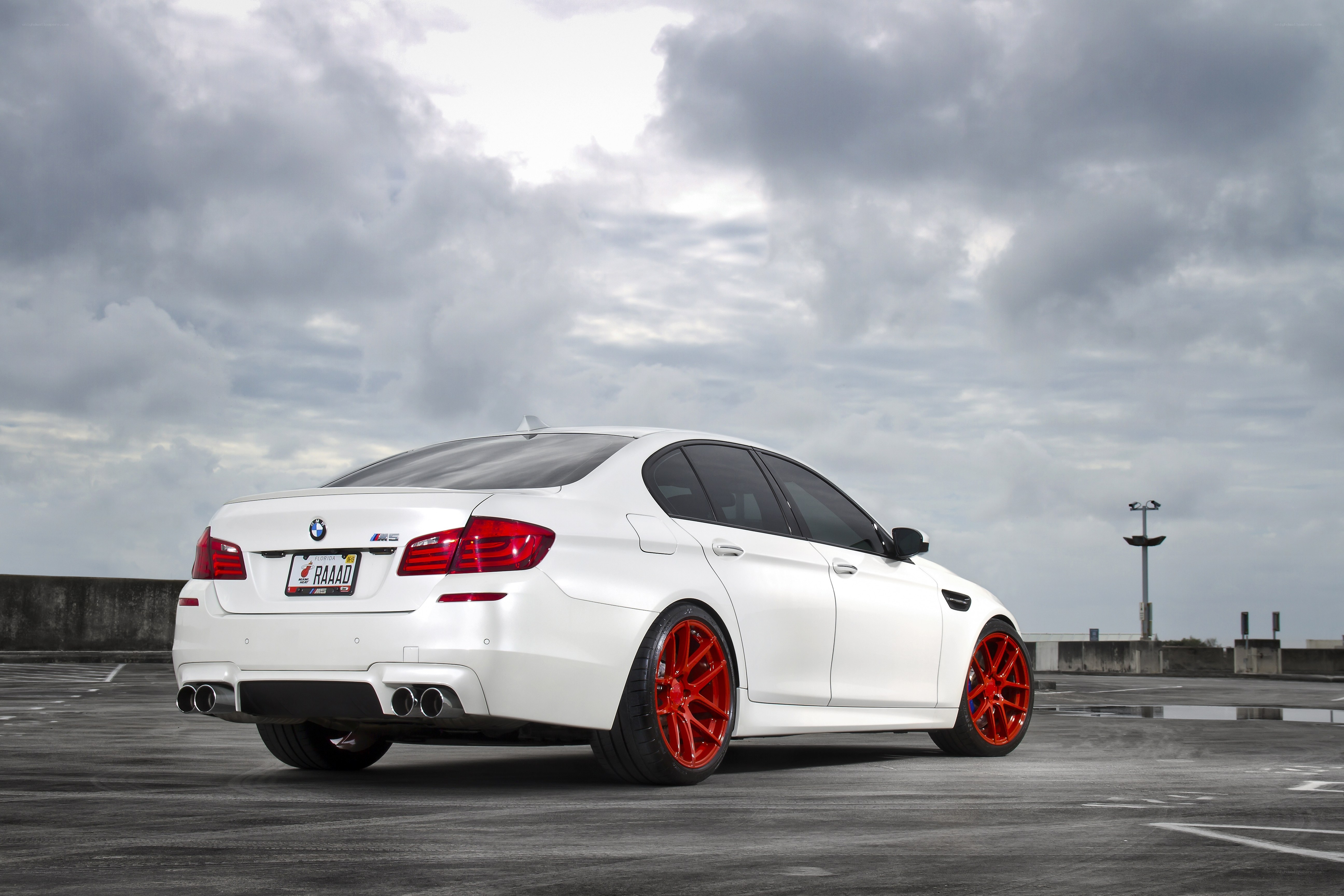 White BMW M5 with red wheels