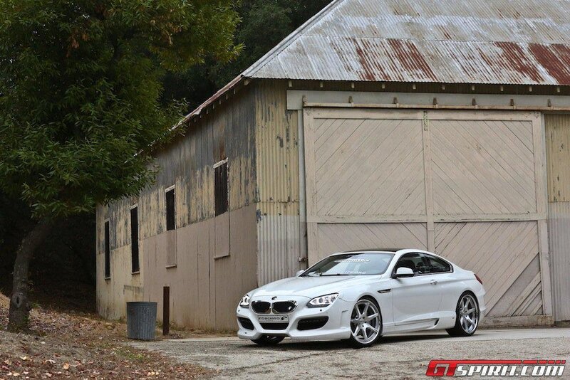 White BMW M6 in front of barn