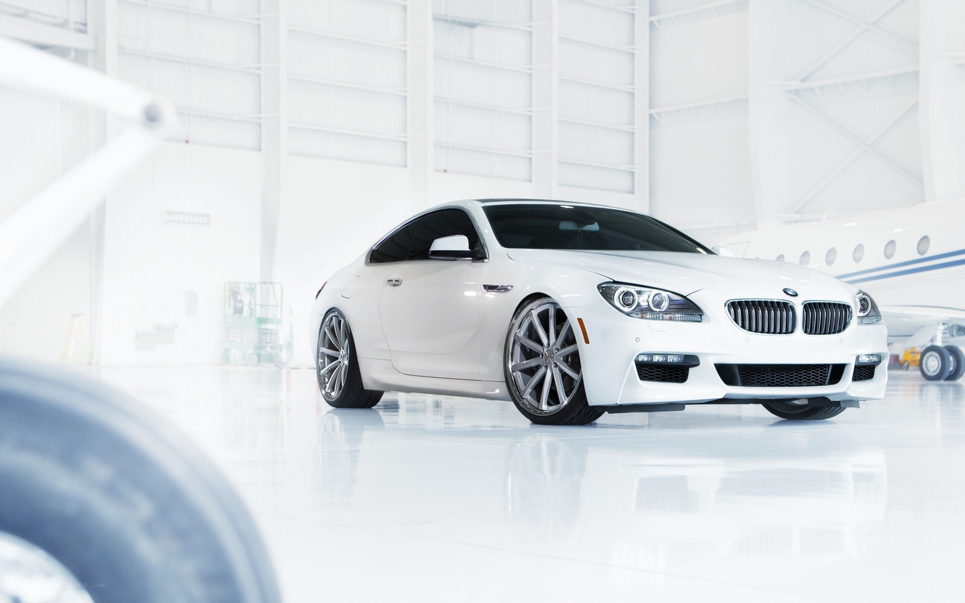 White BMW M6 in hangar