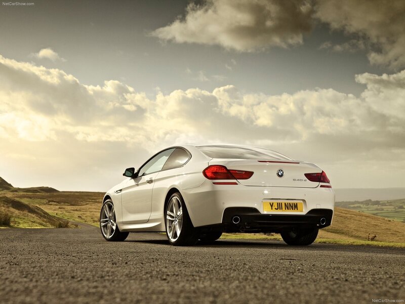 White BMW M6 on a country road