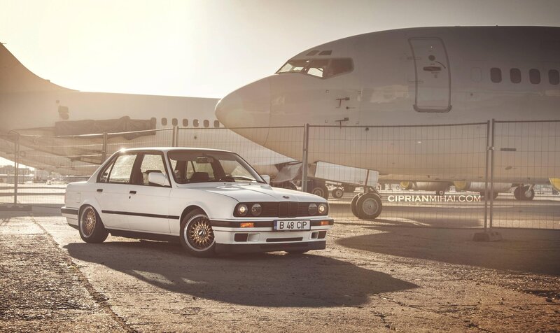 White BMW near airplane