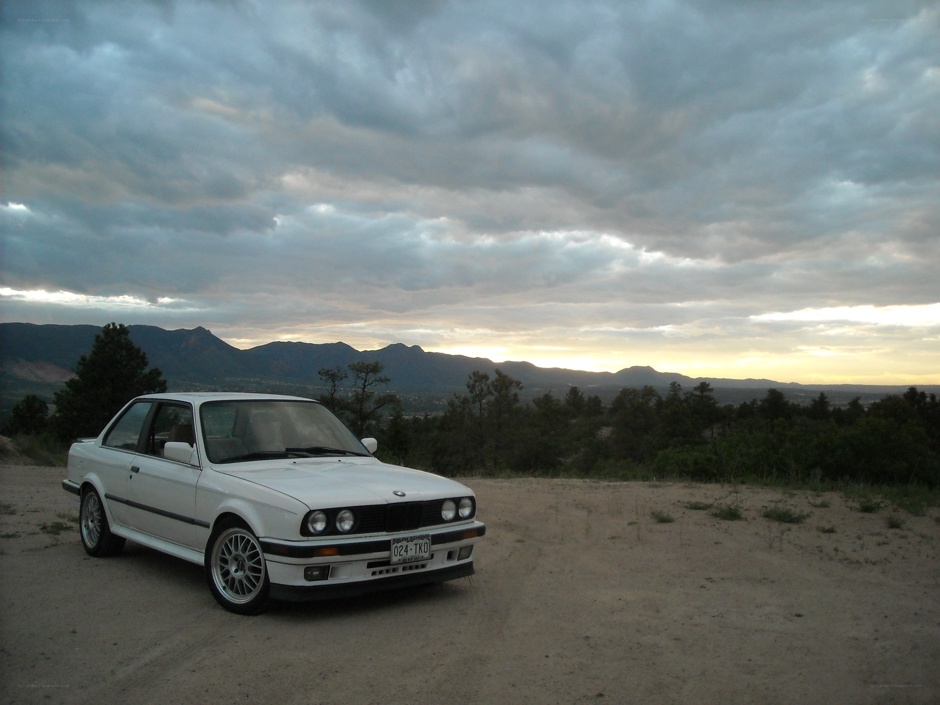 White BMW on a dirt road