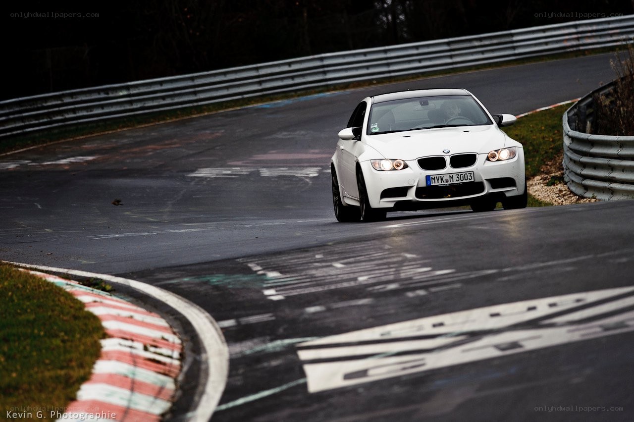 White BMW on a racetrack