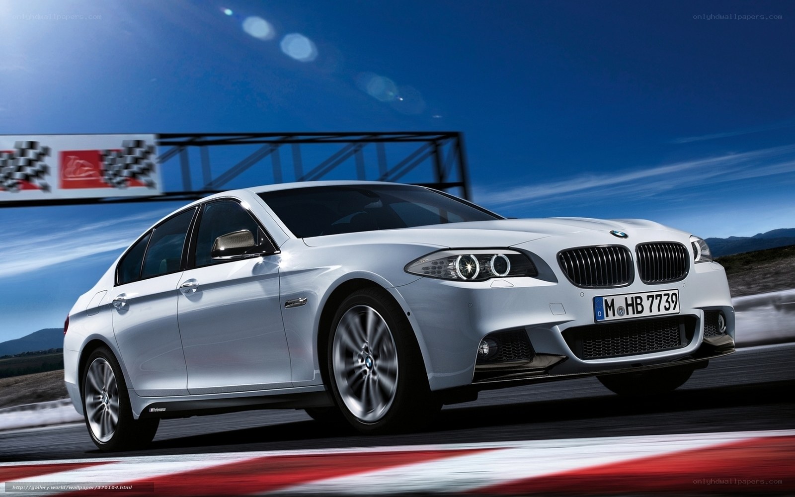 White BMW on a racetrack