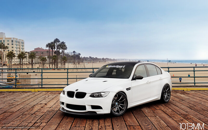 White BMW on a wooden pier