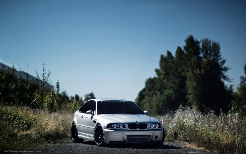 white bmw on gravel road