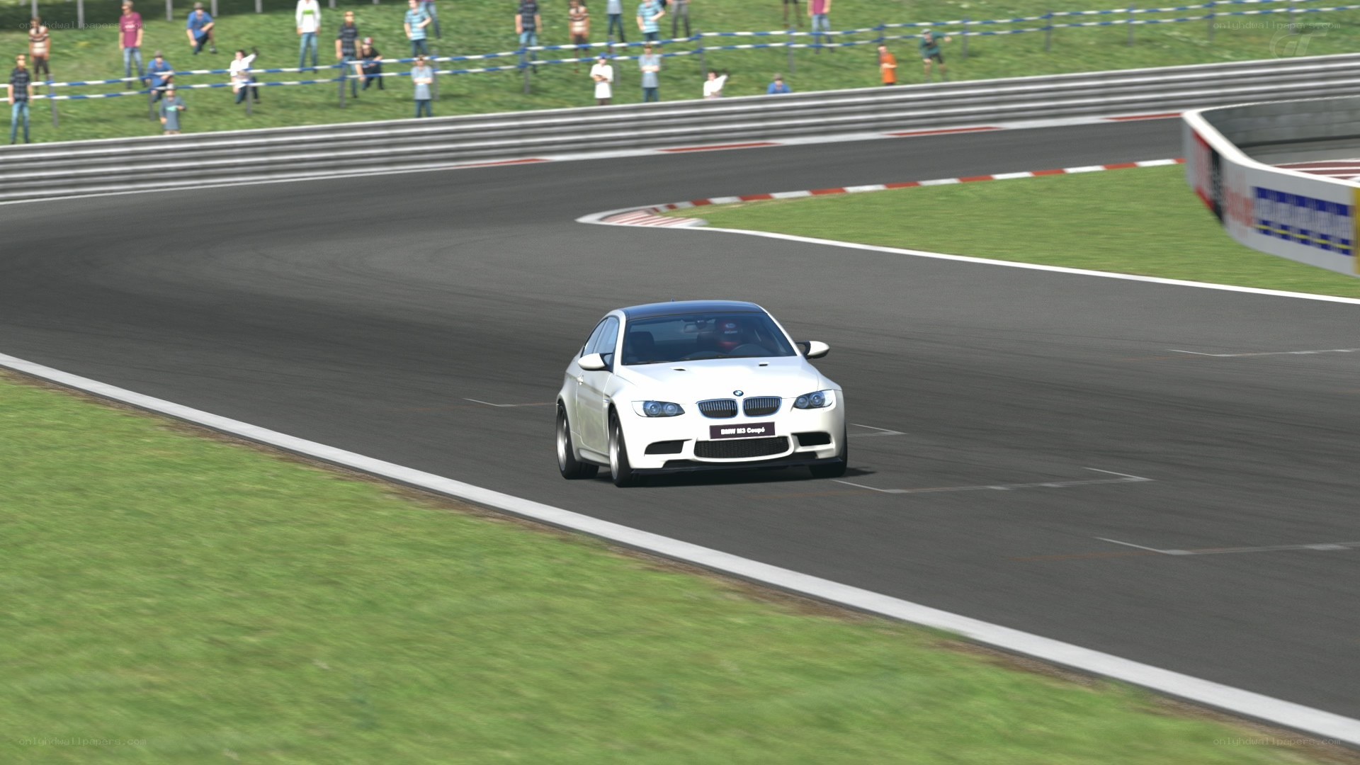 White BMW on racetrack