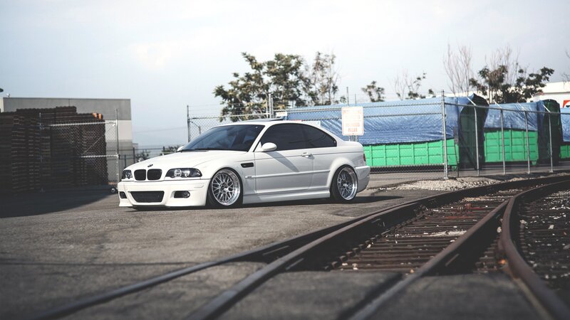 white bmw on train tracks